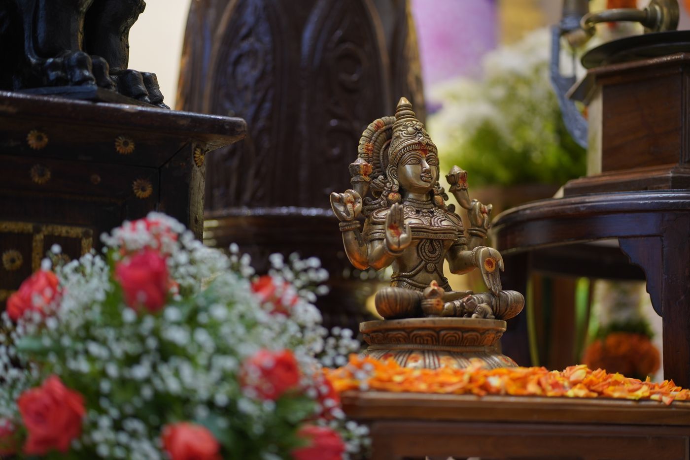 A beautifully decorated deity adorned with fresh flower garlands