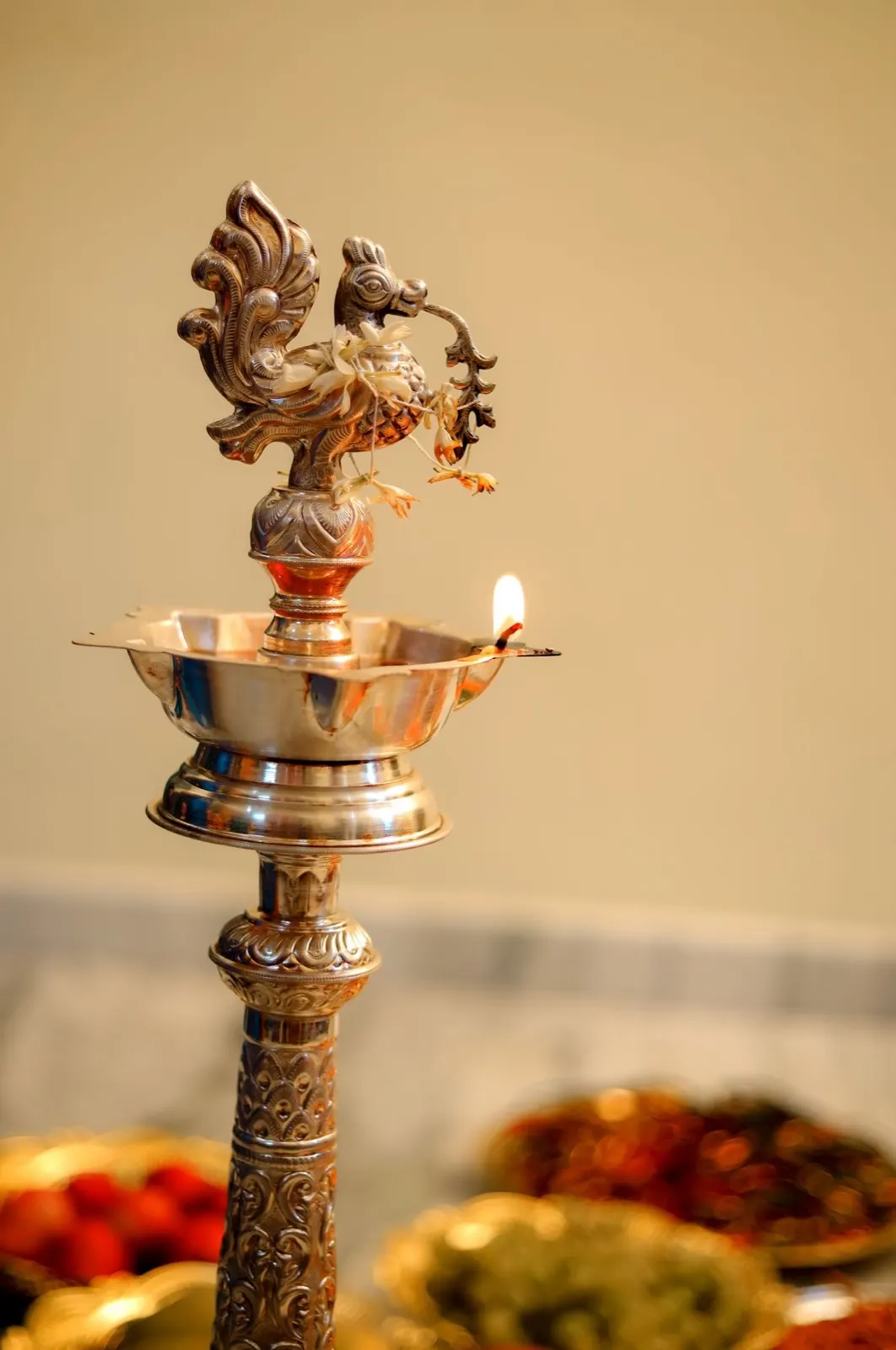 A lit brass oil lamp during temple aarti