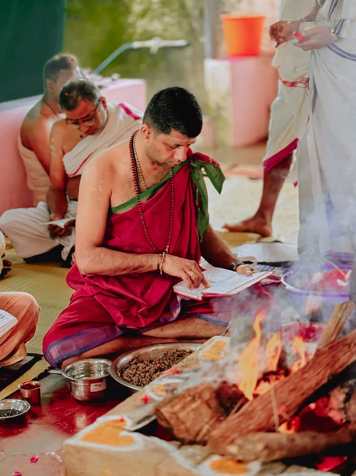 Pujaris performing a traditional havan (sacred fire ritual) with offerings