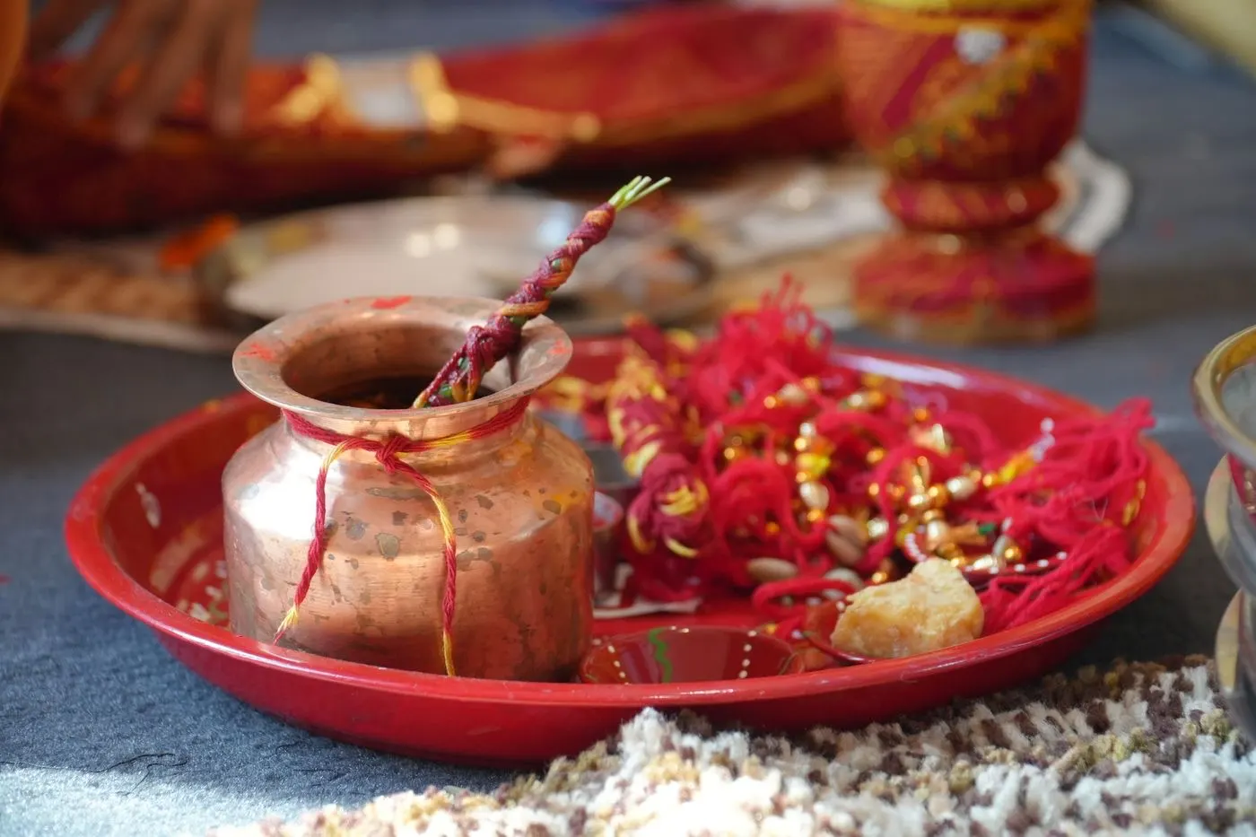 Traditional pooja thali with copper vessels and offerings